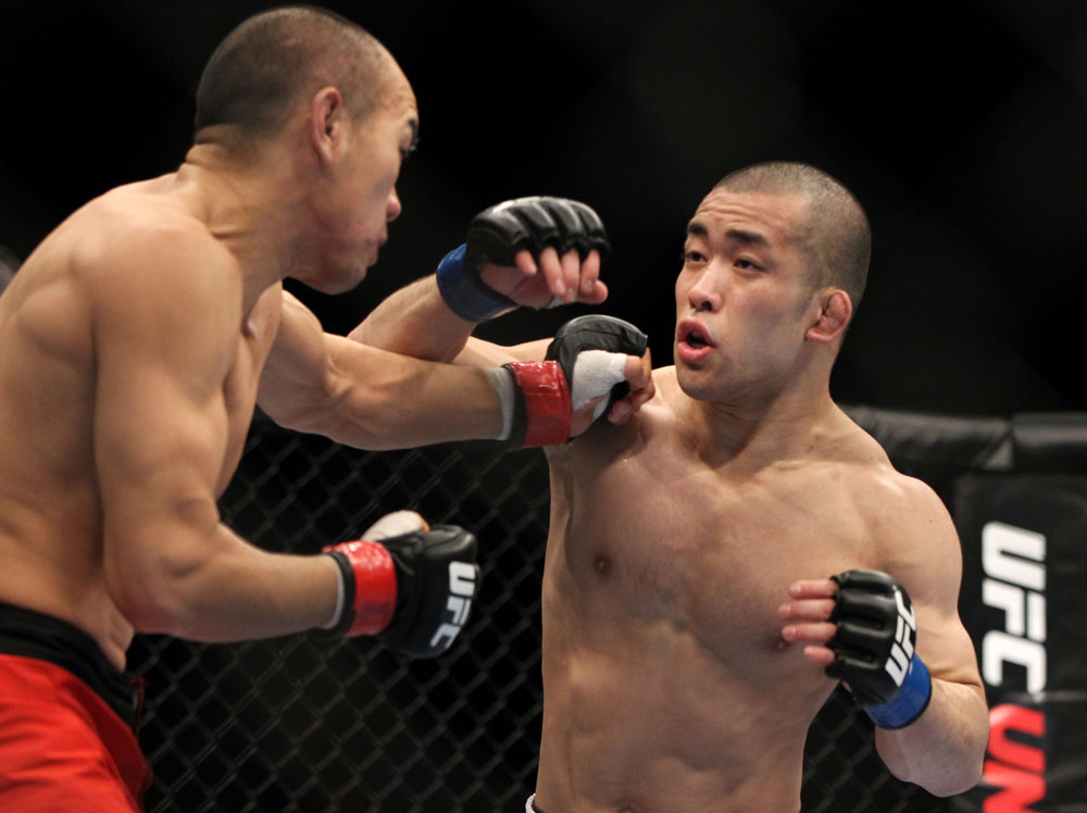 SAITAMA, JAPAN - FEBRUARY 26:  (R-L) Issei Tamura and Tiequan Zhang trade punches during the UFC 144 event at Saitama Super Arena on February 26, 2012 in Saitama, Japan.  (Photo by Josh Hedges/Zuffa LLC/Zuffa LLC via Getty Images) *** Local Caption *** Tiequan Zhang; Issei Tamura