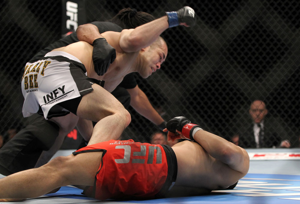 SAITAMA, JAPAN - FEBRUARY 26:  (L-R) Issei Tamura knocks out Tiequan Zhang with a punch on the ground during the UFC 144 event at Saitama Super Arena on February 26, 2012 in Saitama, Japan.  (Photo by Josh Hedges/Zuffa LLC/Zuffa LLC via Getty Images) *** Local Caption *** Tiequan Zhang; Issei Tamura