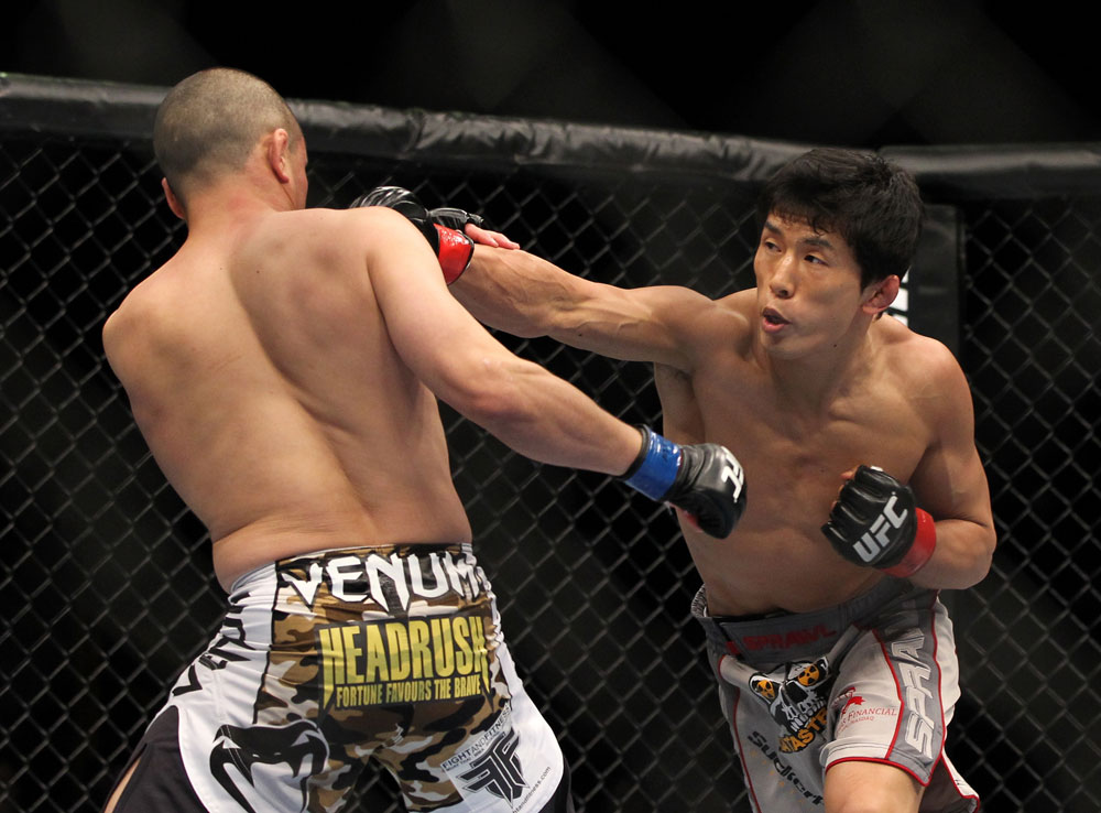 SAITAMA, JAPAN - FEBRUARY 26:  (R-L) Takeya Mizugaki punches Chris Cariaso during the UFC 144 event at Saitama Super Arena on February 26, 2012 in Saitama, Japan.  (Photo by Josh Hedges/Zuffa LLC/Zuffa LLC via Getty Images) *** Local Caption *** Takeya Mizugaki; Chris Cariaso