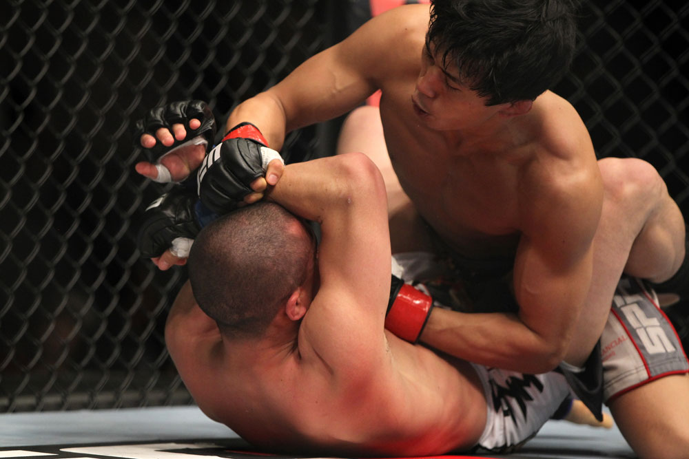 SAITAMA, JAPAN - FEBRUARY 26:  (R-L) Takeya Mizugaki punches Chris Cariaso during the UFC 144 event at Saitama Super Arena on February 26, 2012 in Saitama, Japan.  (Photo by Josh Hedges/Zuffa LLC/Zuffa LLC via Getty Images) *** Local Caption *** Takeya Mizugaki; Chris Cariaso