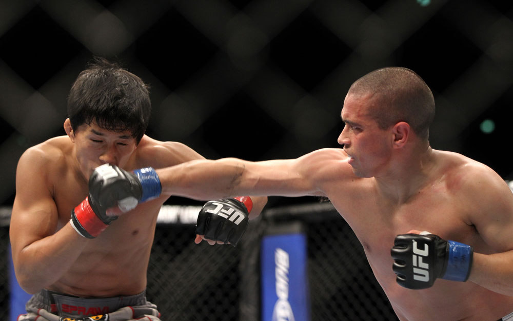 SAITAMA, JAPAN - FEBRUARY 26:  (R-L) Chris Cariaso punches Takeya Mizugaki during the UFC 144 event at Saitama Super Arena on February 26, 2012 in Saitama, Japan.  (Photo by Josh Hedges/Zuffa LLC/Zuffa LLC via Getty Images) *** Local Caption *** Takeya Mizugaki; Chris Cariaso