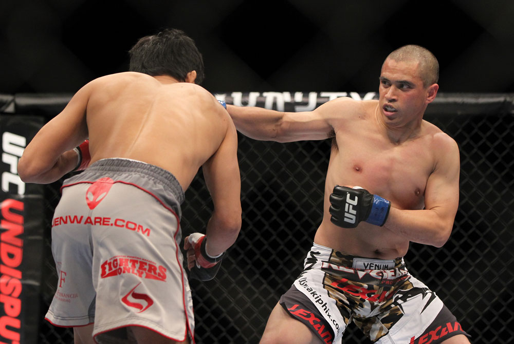 SAITAMA, JAPAN - FEBRUARY 26:  (R-L) Chris Cariaso punches Takeya Mizugaki during the UFC 144 event at Saitama Super Arena on February 26, 2012 in Saitama, Japan.  (Photo by Josh Hedges/Zuffa LLC/Zuffa LLC via Getty Images) *** Local Caption *** Takeya Mizugaki; Chris Cariaso
