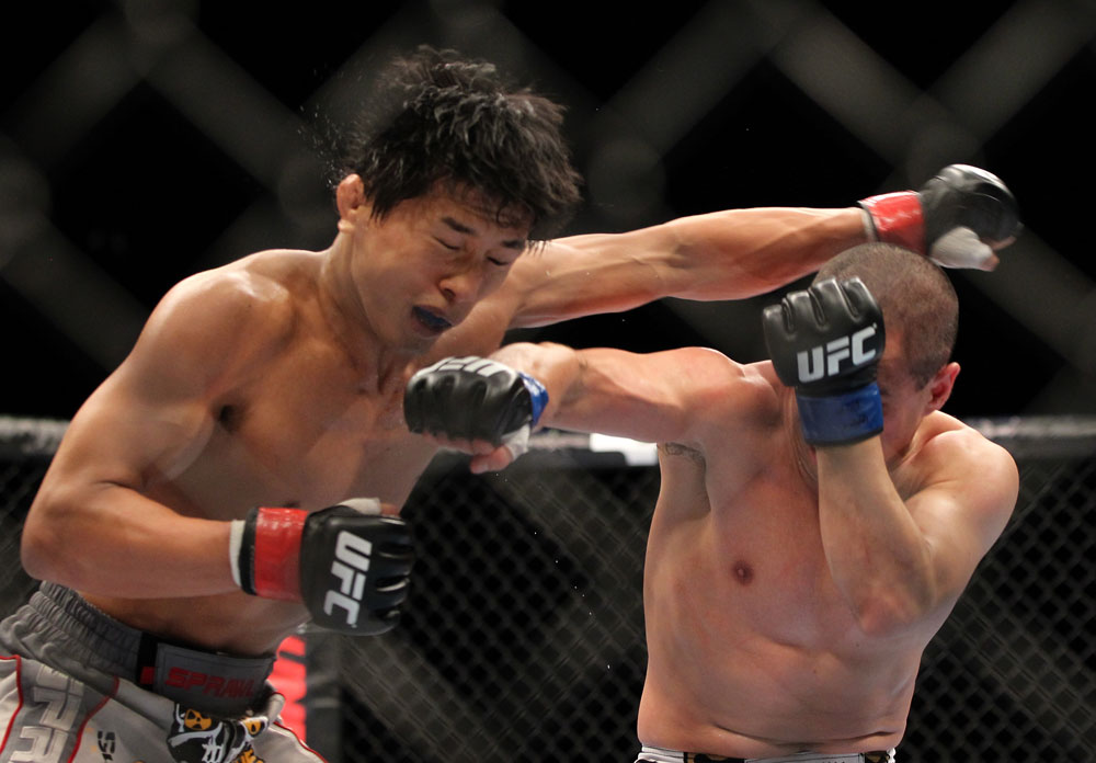 SAITAMA, JAPAN - FEBRUARY 26:  (R-L) Chris Cariaso punches Takeya Mizugaki during the UFC 144 event at Saitama Super Arena on February 26, 2012 in Saitama, Japan.  (Photo by Josh Hedges/Zuffa LLC/Zuffa LLC via Getty Images) *** Local Caption *** Takeya Mizugaki; Chris Cariaso