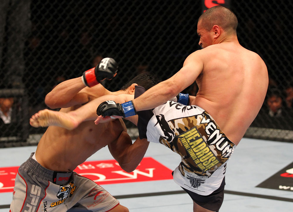 SAITAMA, JAPAN - FEBRUARY 26:  (R-L) Chris Cariaso kicks Takeya Mizugaki during the UFC 144 event at Saitama Super Arena on February 26, 2012 in Saitama, Japan.  (Photo by Al Bello/Zuffa LLC/Zuffa LLC via Getty Images) *** Local Caption *** Takeya Mizugaki; Chris Cariaso
