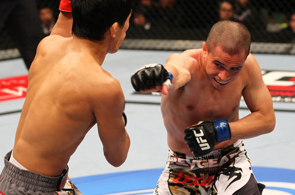 SAITAMA, JAPAN - FEBRUARY 26:  (R-L) Chris Cariaso punches Takeya Mizugaki during the UFC 144 event at Saitama Super Arena on February 26, 2012 in Saitama, Japan.  (Photo by Al Bello/Zuffa LLC/Zuffa LLC via Getty Images) *** Local Caption *** Takeya Mizugaki; Chris Cariaso