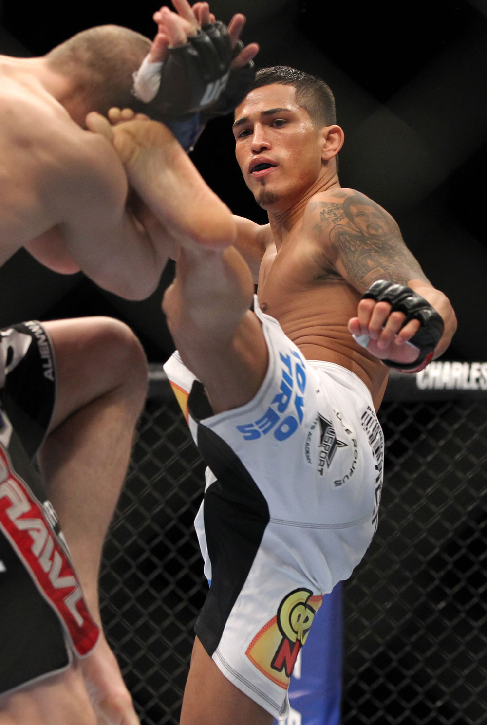 SAITAMA, JAPAN - FEBRUARY 26:  (R-L) Anthony Pettis kicks Joe Lauzon during the UFC 144 event at Saitama Super Arena on February 26, 2012 in Saitama, Japan.  (Photo by Josh Hedges/Zuffa LLC/Zuffa LLC via Getty Images) *** Local Caption *** Anthony Pettis; Joe Lauzon