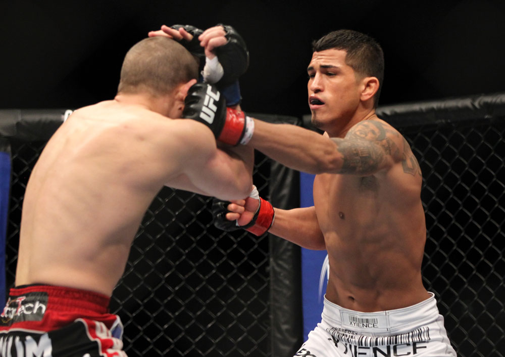 SAITAMA, JAPAN - FEBRUARY 26:  (R-L) Anthony Pettis punches Joe Lauzon during the UFC 144 event at Saitama Super Arena on February 26, 2012 in Saitama, Japan.  (Photo by Josh Hedges/Zuffa LLC/Zuffa LLC via Getty Images) *** Local Caption *** Anthony Pettis; Joe Lauzon