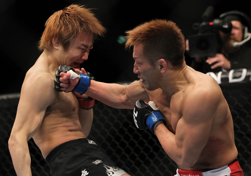 SAITAMA, JAPAN - FEBRUARY 26:  (R-L) Eiji Mitsuoka punches Takanori Gomi during the UFC 144 event at Saitama Super Arena on February 26, 2012 in Saitama, Japan.  (Photo by Josh Hedges/Zuffa LLC/Zuffa LLC via Getty Images) *** Local Caption *** Takanori Gomi; Eiji Mitsuoka