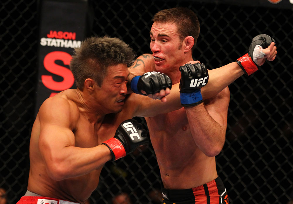 SAITAMA, JAPAN - FEBRUARY 26:  (R-L) Jake Shields punches Yoshihiro Akiyama during the UFC 144 event at Saitama Super Arena on February 26, 2012 in Saitama, Japan.  (Photo by Al Bello/Zuffa LLC/Zuffa LLC via Getty Images) *** Local Caption *** Yoshihiro Akiyama; Jake Shields