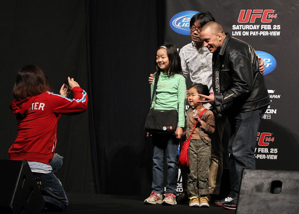 SAITAMA, JAPAN - FEBRUARY 25: UFC Welterweight Champion Georges St-Pierre poses for photos with fans before the official UFC 144 weigh in at the Saitama Super Arena on February 25, 2012 in Saitama, Japan. (Photo by Josh Hedges/Zuffa LLC/Zuffa LLC via Getty Images) *** Local Caption *** Georges St-Pierre