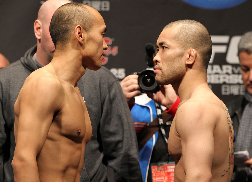 SAITAMA, JAPAN - FEBRUARY 25:  (L-R) Opponents Tiequan Zhang and Issei Tamura face off after weighing in during the official UFC 144 weigh in at the Saitama Super Arena on February 25, 2012 in Saitama, Japan.  (Photo by Josh Hedges/Zuffa LLC/Zuffa LLC via Getty Images) *** Local Caption *** Tiequan Zhang; Issei Tamura