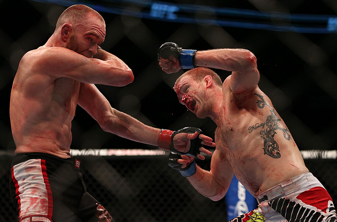 TORONTO, CANADA - SEPTEMBER 22: (R-L) Evan Dunham punches T.J. Grant during their lightweight bout at UFC 152 inside Air Canada Centre on September 22, 2012 in Toronto, Ontario, Canada. (Photo by Josh Hedges/Zuffa LLC/Zuffa LLC via Getty Images)