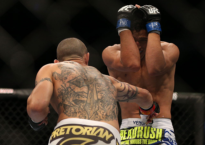 TORONTO, CANADA - SEPTEMBER 22: (L-R) Cub Swanson punches to the body of Charles Oliveira during their featherweight bout at UFC 152 inside Air Canada Centre on September 22, 2012 in Toronto, Ontario, Canada. (Photo by Josh Hedges/Zuffa LLC/Zuffa LLC via Getty Images)