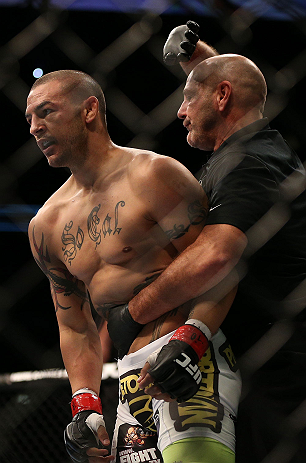 TORONTO, CANADA - SEPTEMBER 22: (R-L) Referee Yves Lavigne pulls Cub Swanson away after his knockout of Charles Oliveira during their featherweight bout at UFC 152 inside Air Canada Centre on September 22, 2012 in Toronto, Ontario, Canada. (Photo by Josh Hedges/Zuffa LLC/Zuffa LLC via Getty Images)