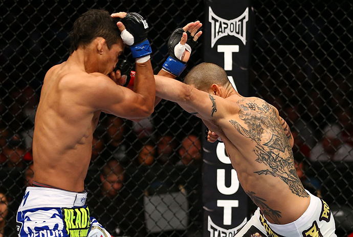 TORONTO, CANADA - SEPTEMBER 22:    (R-L) Cub Swanson punches Charles Oliveira during their featherweight bout at UFC 152 inside Air Canada Centre on September 22, 2012 in Toronto, Ontario, Canada.  (Photo by Al Bello/Zuffa LLC/Zuffa LLC via Getty Images)