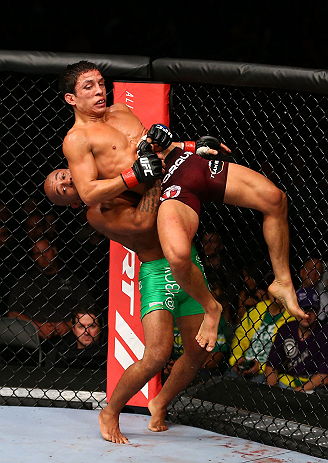 TORONTO, CANADA - SEPTEMBER 22: Demetrious Johnson (green shorts) takes down Joseph Benavidez during their flyweight championship bout at UFC 152 inside Air Canada Centre on September 22, 2012 in Toronto, Ontario, Canada. (Photo by Al Bello/Zuffa LLC/Zuffa LLC via Getty Images)