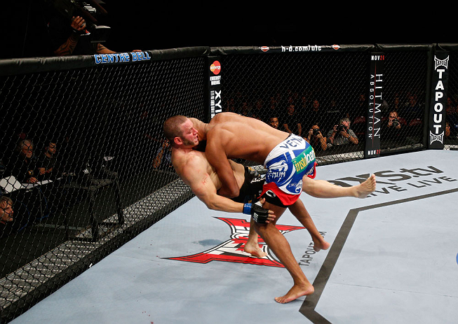 MONTREAL, QC - NOVEMBER 17:  Cyrille Diabate takes down Chad Griggs in their light heavyweight bout during UFC 154 on November 17, 2012  at the Bell Centre in Montreal, Canada.  (Photo by Josh Hedges/Zuffa LLC/Zuffa LLC via Getty Images)