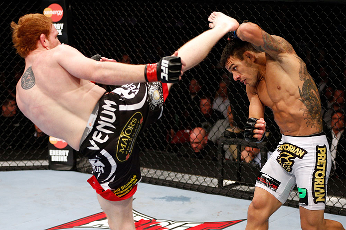 MONTREAL, QC - NOVEMBER 17:  Rafael dos Anjos (R)  blocks a kick from Mark Bocek in their lightweight bout during UFC 154 on November 17, 2012  at the Bell Centre in Montreal, Canada.  (Photo by Josh Hedges/Zuffa LLC/Zuffa LLC via Getty Images)