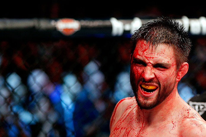 MONTREAL, QC - NOVEMBER 17:  A cut and bloodied Carlos Condit reacts after a round against Georges St-Pierre in their welterweight title bout during UFC 154 on November 17, 2012  at the Bell Centre in Montreal, Canada.  (Photo by Josh Hedges/Zuffa LLC/Zuffa LLC via Getty Images)