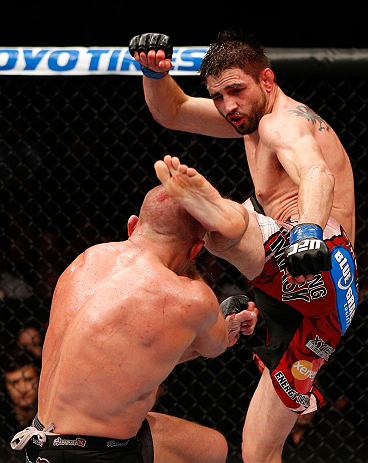 MONTREAL, QC - NOVEMBER 17:  Carlos Condit lands a left footed kick to the head of Georges St-Pierre in their welterweight title bout during UFC 154 on November 17, 2012  at the Bell Centre in Montreal, Canada.  (Photo by Josh Hedges/Zuffa LLC/Zuffa LLC via Getty Images)