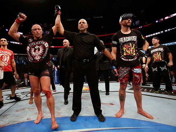 MONTREAL, QC - NOVEMBER 17:  Georges St-Pierre (L) reacts after winning his fight against Carlos Condit by a unanimous decision to retain his welterweight title during UFC 154 on November 17, 2012  at the Bell Centre in Montreal, Canada.  (Photo by Josh Hedges/Zuffa LLC/Zuffa LLC via Getty Images)