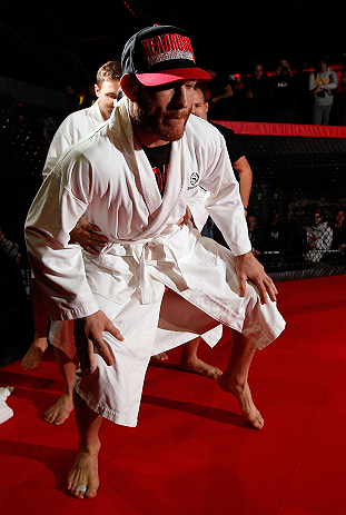 MONTREAL, CANADA - NOVEMBER 15:  Tom Lawlor performs a sumo workout routine for media and fans during an open training session ahead of UFC 154 at New City Gas on November 15, 2012 in Montreal, Quebec, Canada.  (Photo by Josh Hedges/Zuffa LLC/Zuffa LLC via Getty Images)