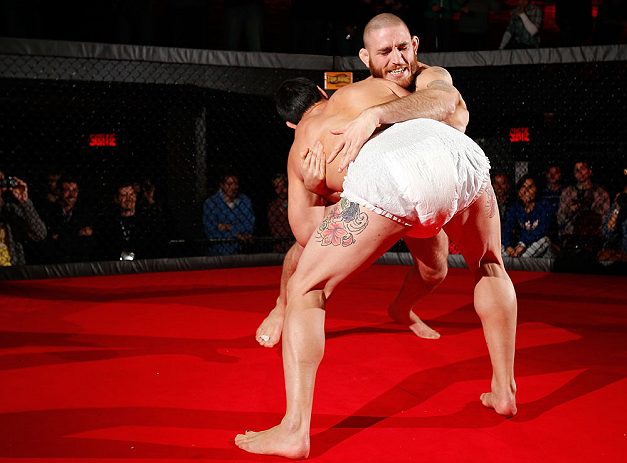 MONTREAL, CANADA - NOVEMBER 15:  Tom Lawlor performs a sumo workout routine for media and fans during an open training session ahead of UFC 154 at New City Gas on November 15, 2012 in Montreal, Quebec, Canada.  (Photo by Josh Hedges/Zuffa LLC/Zuffa LLC via Getty Images)