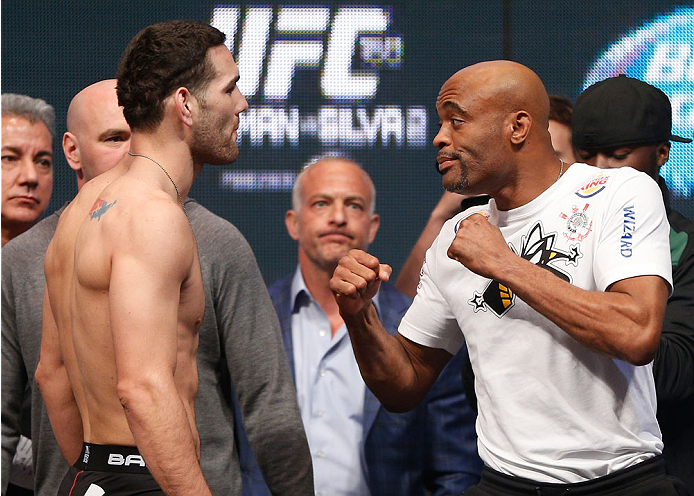 LAS VEGAS, NV - DECEMBER 27:  (L-R) Opponents Chris Weidman and Anderson Silva face off during the UFC 168 weigh-in at the MGM Grand Garden Arena on December 27, 2013 in Las Vegas, Nevada. (Photo by Josh Hedges/Zuffa LLC/Zuffa LLC via Getty Images)