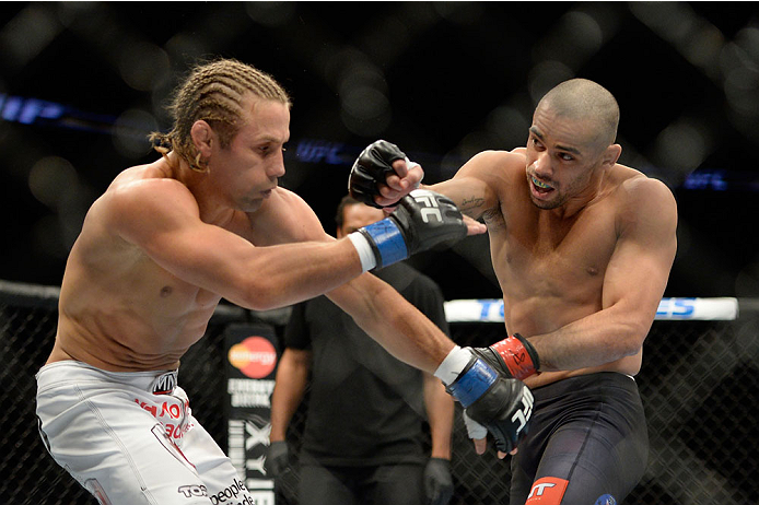 NEWARK, NJ - FEBRUARY 1:  (R-L) Renan Barao punches Uriah Faber in their bantamweight championship fight during the UFC 169 event at the Prudential Center on February 1, 2014 in Newark, New Jersey. (Photo by Jeff Bottari/Zuffa LLC/Zuffa LLC via Getty Images)
