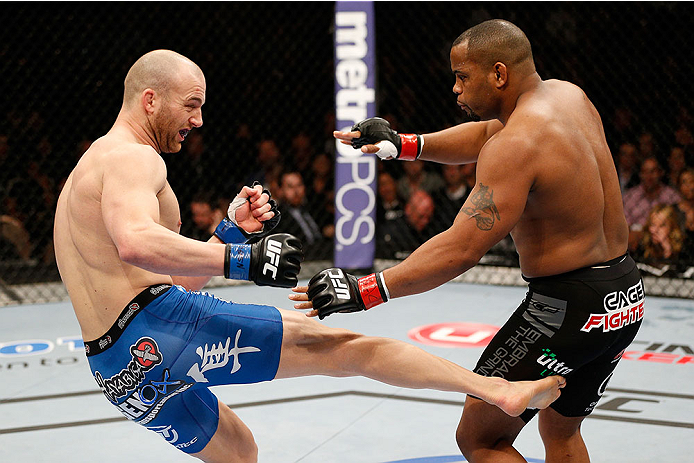 Patrick Cummins kicks Daniel Cormier in their light heavyweight bout during UFC 170 on February 22, 2014 in Las Vegas, NV. (Photo by Josh Hedges/Zuffa LLC)