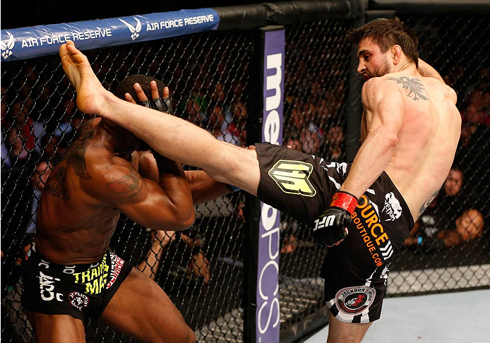 DALLAS, TX - MARCH 15: (R-L) Carlos Condit punches Tyron Woodley in their welterweight bout at UFC 171 inside American Airlines Center on March 15, 2014 in Dallas, Texas. (Photo by Josh Hedges/Zuffa LLC/Zuffa LLCs)