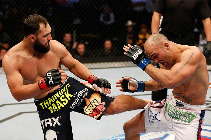 DALLAS, TX - MARCH 15:  (L-R) Johny Hendricks kicks Robbie Lawler in their UFC welterweight championship bout at UFC 171 inside American Airlines Center on March 15, 2014 in Dallas, Texas. (Photo by Josh Hedges/Zuffa LLC/Zuffa LLC via Getty Images)