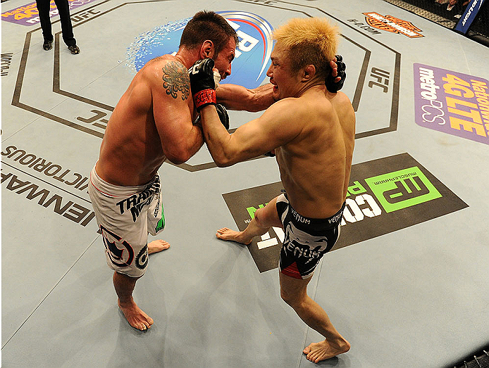 BALTIMORE, MD - APRIL 26:  (R-L) Takanori Gomi punches Isaac Vallie-Flagg in their lightweight bout during the UFC 172 event at the Baltimore Arena on April 26, 2014 in Baltimore, Maryland. (Photo by Patrick Smith/Zuffa LLC/Zuffa LLC via Getty Images)
