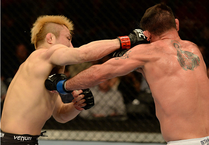 BALTIMORE, MD - APRIL 26:  (L-R) Takanori Gomi punches Isaac Vallie-Flagg in their lightweight bout during the UFC 172 event at the Baltimore Arena on April 26, 2014 in Baltimore, Maryland. (Photo by Patrick Smith/Zuffa LLC/Zuffa LLC via Getty Images)