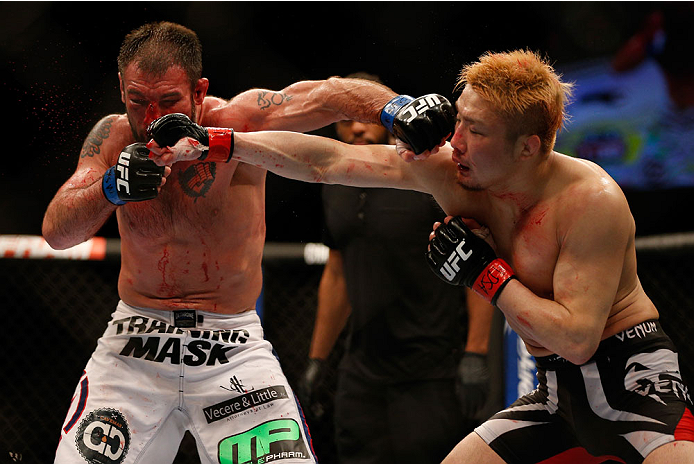 BALTIMORE, MD - APRIL 26: (R-L) Takanori Gomi and Isaac Vallie-Flagg trade punches in their lightweight bout during the UFC 172 event at the Baltimore Arena on April 26, 2014 in Baltimore, Maryland. (Photo by Josh Hedges/Zuffa LLC/Zuffa LLC via Getty Images)