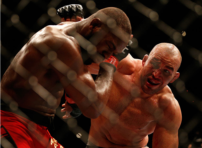 BALTIMORE, MD - APRIL 26:  (R-L) Glover Teixeira punches Jon "Bones" Jones in their light heavyweight championship bout during the UFC 172 event at the Baltimore Arena on April 26, 2014 in Baltimore, Maryland. (Photo by Josh Hedges/Zuffa LLC/Zuffa LLC via Getty Images)