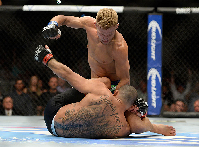 LAS VEGAS, NV - MAY 24:  (R-L) T.J. Dillashaw punches Renan Barao in their bantamweight championship bout during the UFC 173 event at the MGM Grand Garden Arena on May 24, 2014 in Las Vegas, Nevada. (Photo by Jeff Bottari/Zuffa LLC/Zuffa LLC via Getty Images)