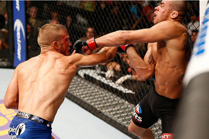 LAS VEGAS, NV - MAY 24:  (L-R) T.J. Dillashaw punches Renan Barao in their bantamweight championship bout during the UFC 173 event at the MGM Grand Garden Arena on May 24, 2014 in Las Vegas, Nevada. (Photo by Josh Hedges/Zuffa LLC/Zuffa LLC via Getty Images)