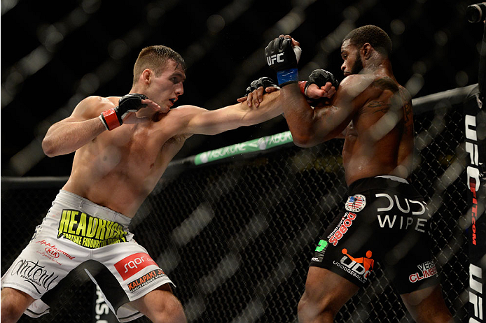 VANCOUVER, BC - JUNE 14:  (L-R) Rory MacDonald punches Tyron Woodley during the UFC 174 event at Rogers Arena on June 14, 2014 in Vancouver, British Columbia, Canada. (Photo by Jeff Bottari/Zuffa LLC/Zuffa LLC via Getty Images)