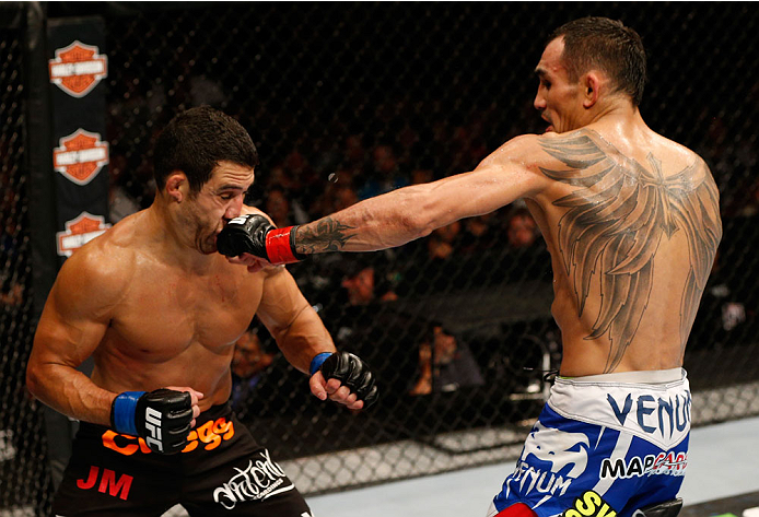 (R-L) Tony Ferguson punhces Danny Castillo in their lightweight bout during the UFC 177 event at Sleep Train Arena on August 30, 2014 in Sacramento, California. (Photo by Josh Hedges/Zuffa LLC)