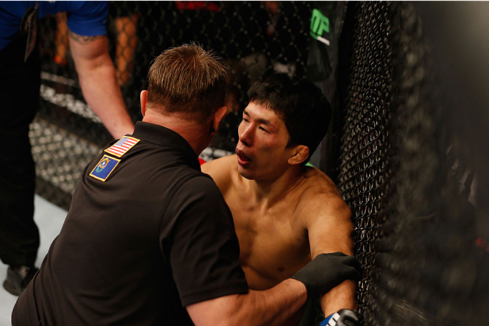 LAS VEGAS, NV - SEPTEMBER 27:  Takeya Mizugaki recovers after losing his fight to Dominick Cruz in their bantamweight fight during the UFC 178 event inside the MGM Grand Garden Arena on September 27, 2014 in Las Vegas, Nevada.  (Photo by Josh Hedges/Zuffa LLC/Zuffa LLC via Getty Images)