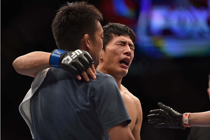 LAS VEGAS, NV - SEPTEMBER 27:  Takeya Mizugaki reacts after his TKO loss from Dominick Cruz in their bantamweight fight during the UFC 178 event inside the MGM Grand Garden Arena on September 27, 2014 in Las Vegas, Nevada.  (Photo by Jeff Bottari/Zuffa LLC/Zuffa LLC via Getty Images)