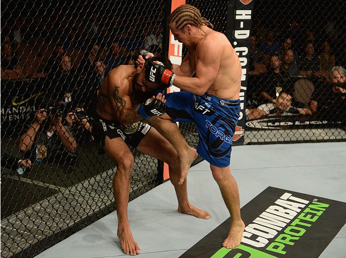 LAS VEGAS, NV - DECEMBER 06: (R-L) Urijah Faber knees Francisco Rivera in their bantamweight bout during the UFC 181 event inside the Mandalay Bay Events Center on December 6, 2014 in Las Vegas, Nevada. (Photo by Robert Laberge/Zuffa LLC/Zuffa LLC via Getty Images)