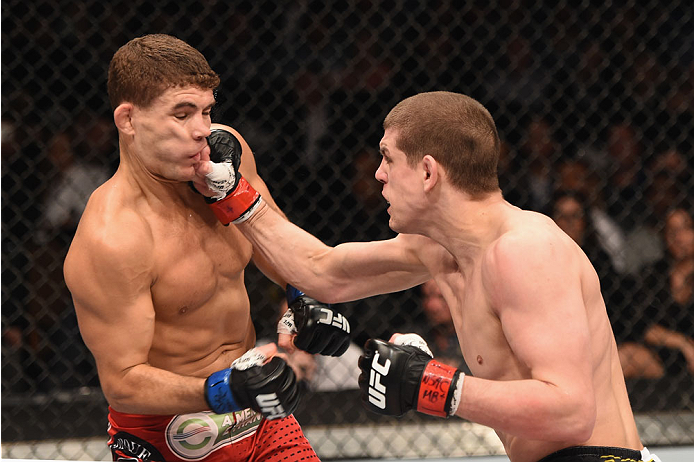 Joe Lauzon punches Al Iaquinta in their bout during the UFC 183 on 1/31/15 in Las Vegas, NV. (Photo by Josh Hedges/Zuffa LLC)