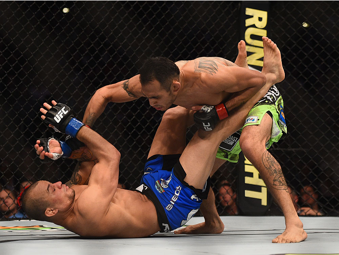 (Top) Tony Ferguson punches Gleison Tibau in their lightweight bout during the UFC 184 event at Staples Center on February 28, 2015 in Los Angeles, California. (Photo by Josh Hedges/Zuffa LLC)