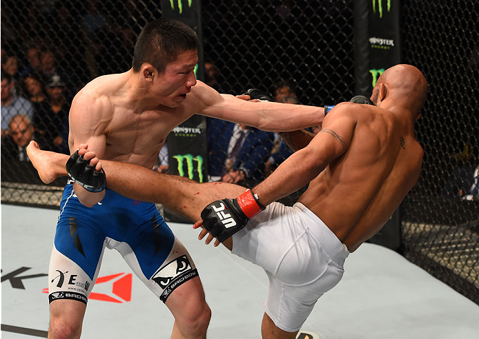 MONTREAL, QC - APRIL 25:   (L-R) Kyoji Horiguchi of Japan punches Demetrious Johnson of the United States in their UFC flyweight championship bout during the UFC 186 event at the Bell Centre on April 25, 2015 in Montreal, Quebec, Canada. (Photo by Josh Hedges/Zuffa LLC/Zuffa LLC via Getty Images)
