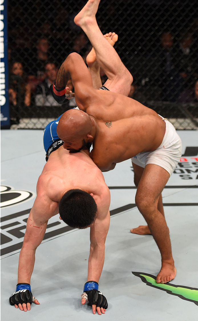 MONTREAL, QC - APRIL 25:   (R-L) Demetrious Johnson of the United States takes down Kyoji Horiguchi of Japan in their UFC flyweight championship bout during the UFC 186 event at the Bell Centre on April 25, 2015 in Montreal, Quebec, Canada. (Photo by Josh Hedges/Zuffa LLC/Zuffa LLC via Getty Images)