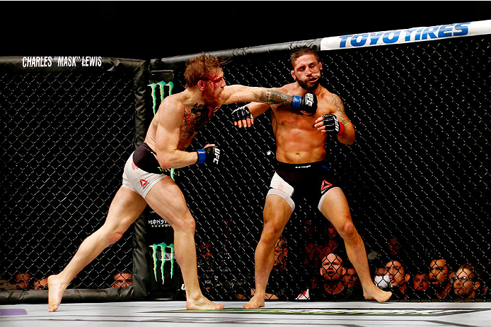 Conor McGregor punches Chad Mendes in their UFC interim featherweight title fight during the UFC 189 event inside MGM Grand Garden Arena on July 11, 2015 in Las Vegas, Nevada. (Photo by Christian Petersen/Zuffa LLC)