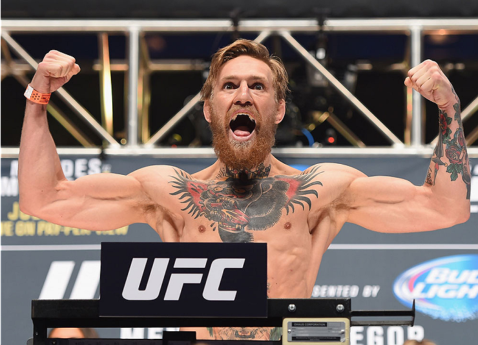 Conor McGregor steps onto the scale during the UFC 189 weigh-in inside MGM Grand Garden Arena on July 10, 2015 in Las Vegas, Nevada. (Photo by Josh Hedges/Zuffa LLC)
