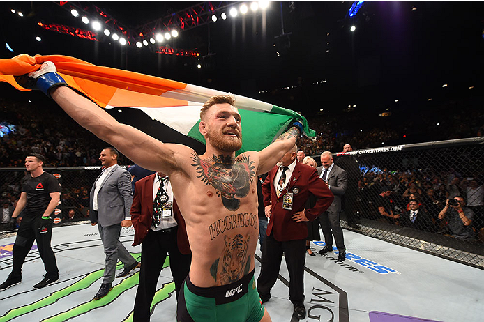 Conor McGregor celebrates after defeating Jose Aldo at UFC 194